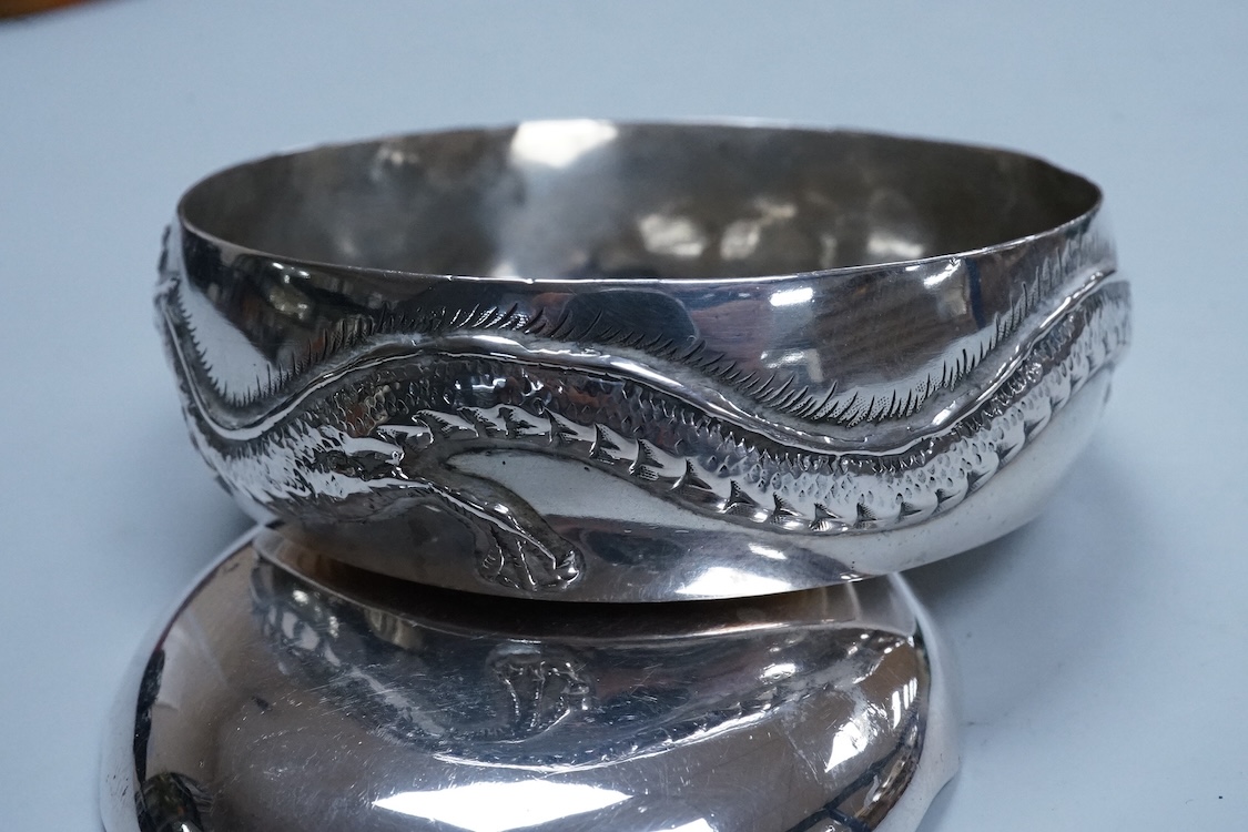 An early 20th century Chinese Export white metal small trinket dish with dragon decoration, by Sing Fat, diameter 66mm, together with a larger Chinese Export white metal trinket dish, maker Tien Shing?.
